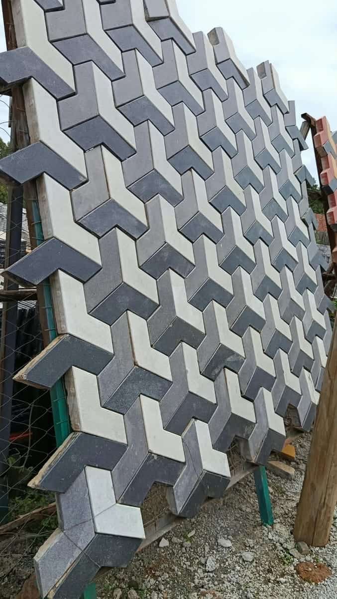 3D hexagon cabro in light grey, mid grey and charcoal creating a tumbling-cube effect, yard display panel