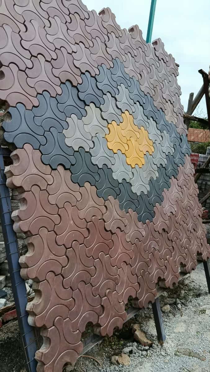 Trihex flower-shaped cabro in red, grey, yellow and charcoal forming a diamond motif, sample panel close-up