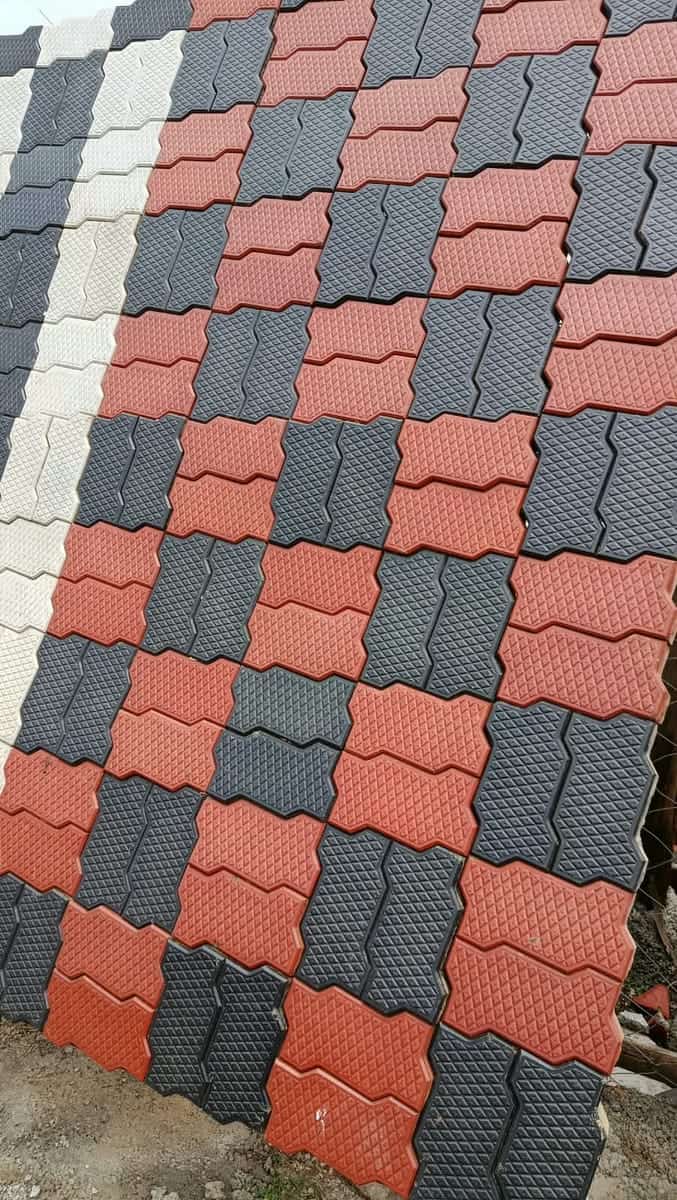Red and charcoal unipaver cabro laid in a checker pattern with a grey border, sample panel