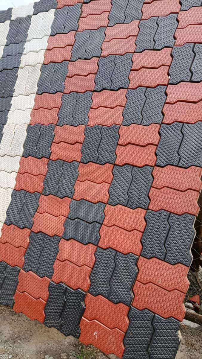 Red, charcoal and grey textured unipaver cabro blocks in a checker layout, sample panel