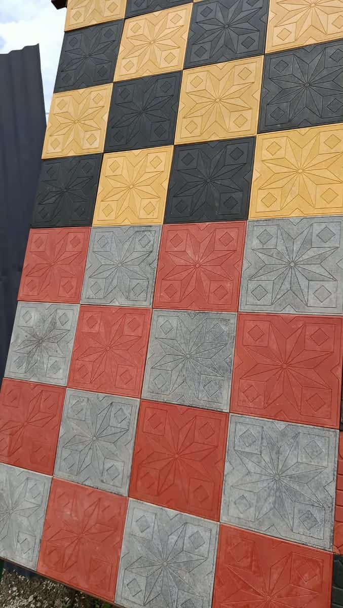 Yellow, charcoal, red and grey embossed sunflower cabro squares in a checker layout